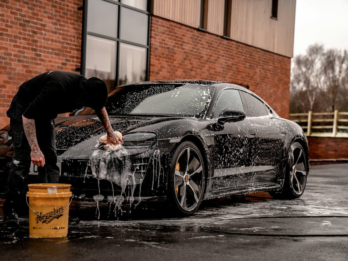 Detailer working on a car in the workshop